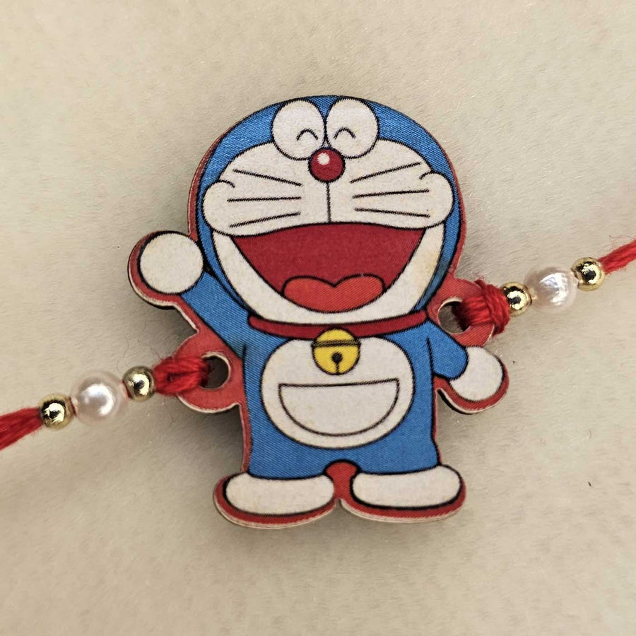 Handmade Doraemon Mdf Wood Kids Rakhi With Roli Chawal - Close-up Front View