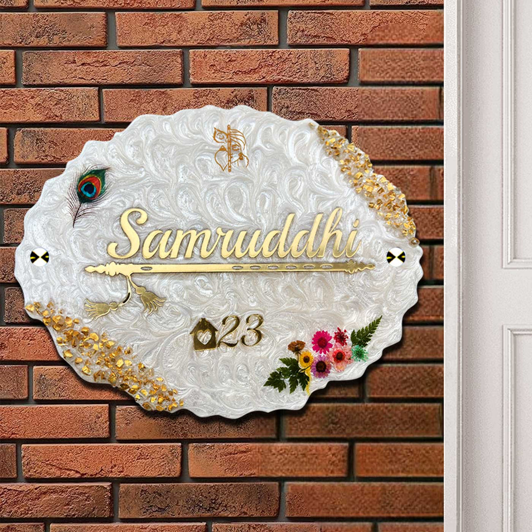 Personalized White Floral Theme Oval Resin And Acrylic Waterproof Name Plate - Mounted on Brick Wall Close-up