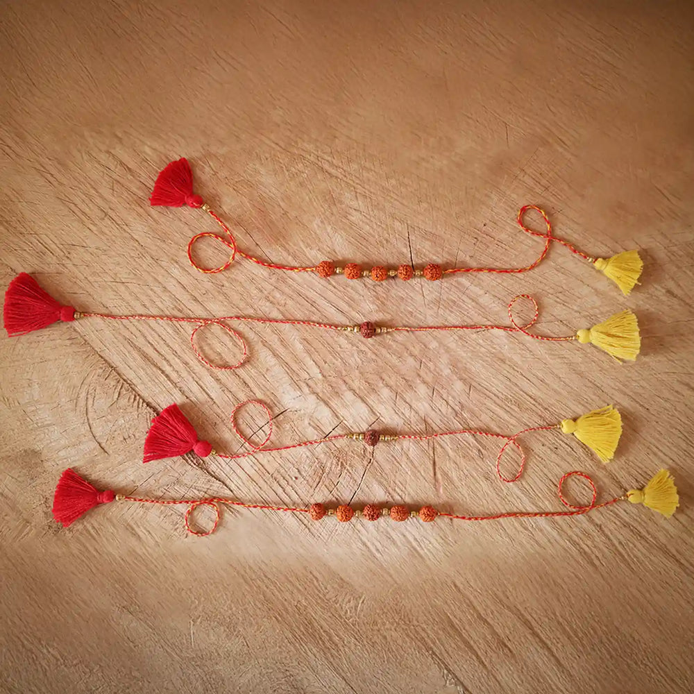 Handmade Crochet One And Five Rudraksha Rakhi With Roli Chawal Set Of 4 - Full length laid flat