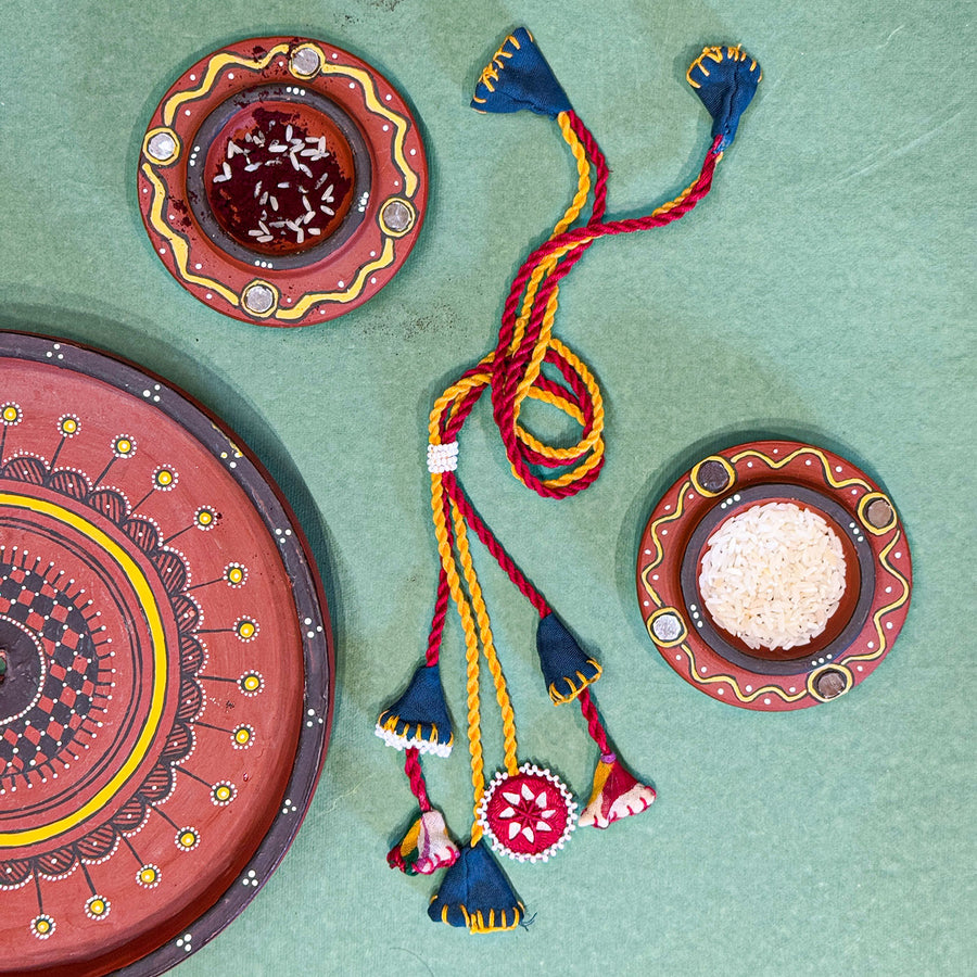 Reusable Mirror And Cotton Rope Rakhi For Bhabhi - Flat Lay Display with Decorative Plates