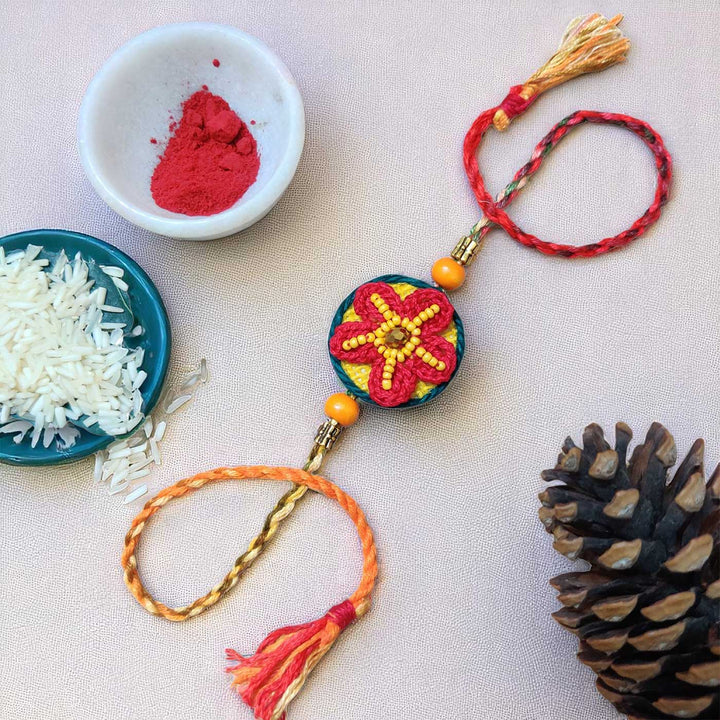 Handmade Crochet Flower Theme Cotton Rakhi With Roli Chawal - Full product with festive accessories