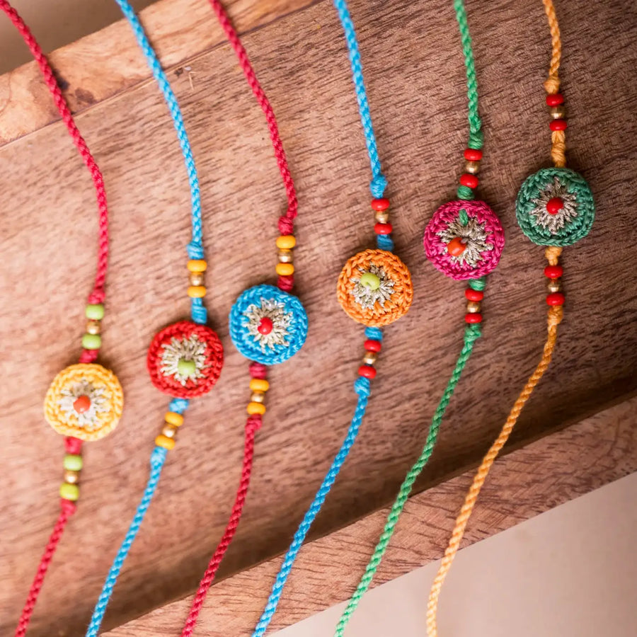 Handmade Crochet Multicolor Round Rakhi With Roli Chawal Set Of 6 - Close-up of Beaded Bracelets