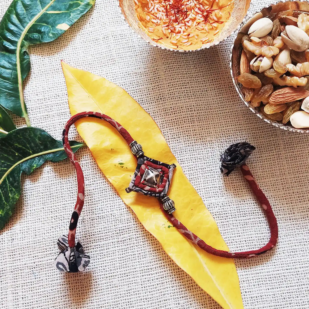 Handmade Dori Work Antique Metal Rakhi With Roli Chawal - Styled with nuts and bowl