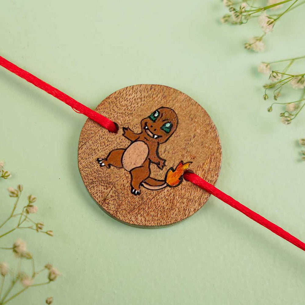 Personalized Hand Painted Charmeleon Theme Wooden Rakhi With Roli Chawal - Close-up on Flat Surface