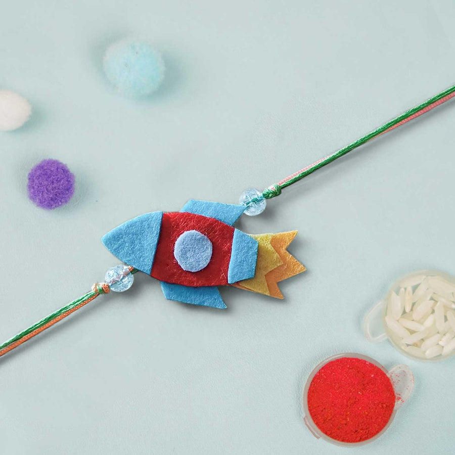 Handmade Rocket Theme Felt Kids Rakhi - Close-up with Decor Items