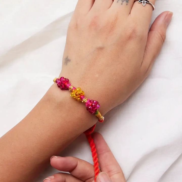 Handmade Beaded Green And Pink Zuzu Rakhi With Roli Chawal Set Of 2 - Close-up of Pink Yellow Bracelet