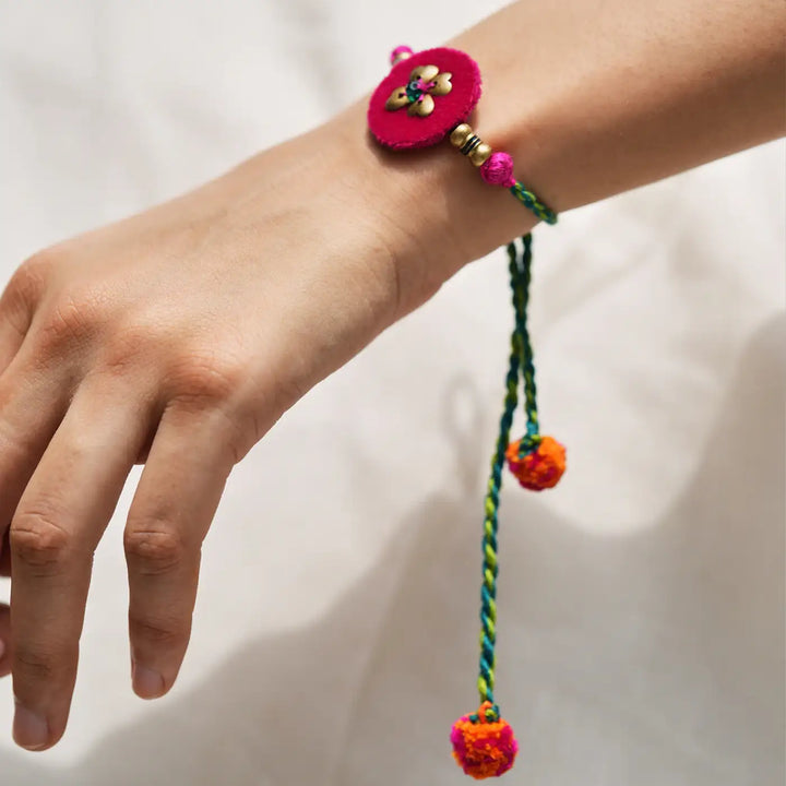 Handmade Embroidered Golden Tassels Kaju Katli Bhaiya Bhabhi Rakhi With Roli Chawal Set Of 2 - Rakhi bracelet close-up on wrist