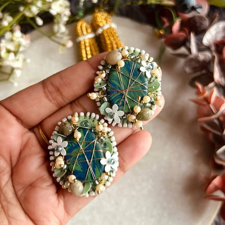 Hand Embroidered Beaded Moni Bhaiya Bhabhi Rakhi With Roli Chawal Set Of 2 - Close-up of Earrings in Hand