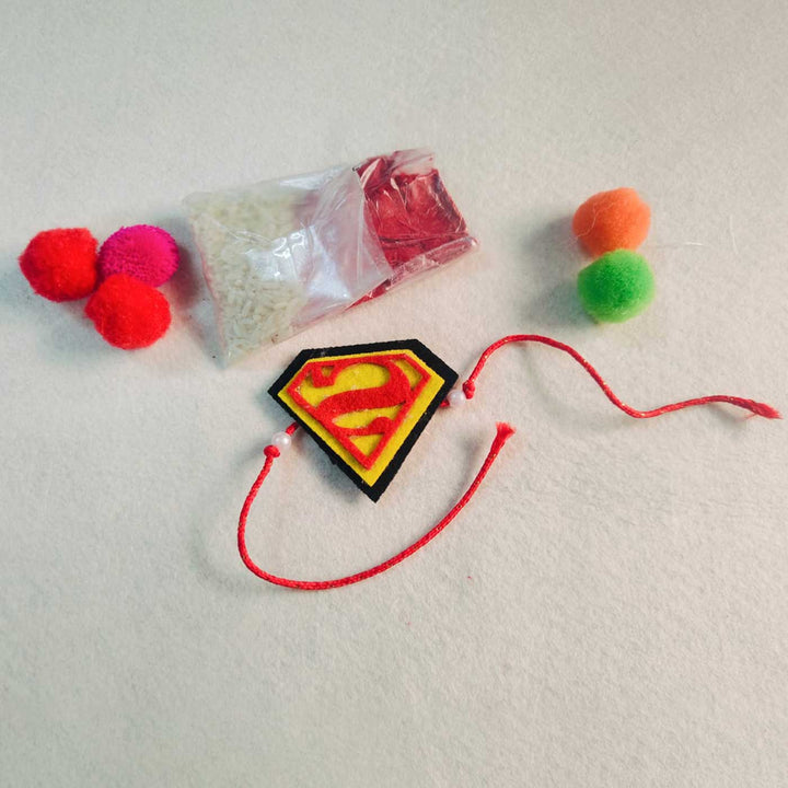 Handmade Beaded Superman Theme Pom Pom Felt Rakhi With Roli Chawal For Kids - Accessory with Decorative Items