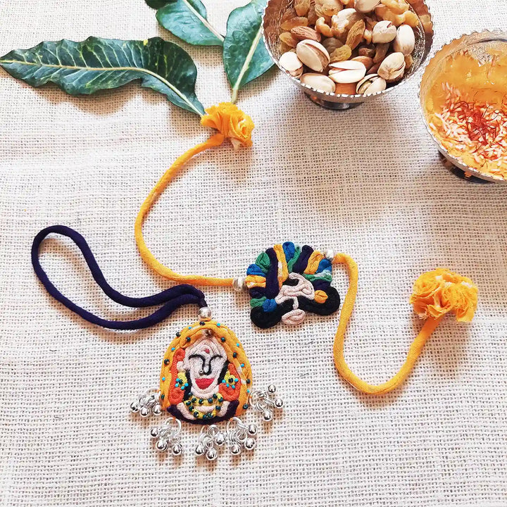 Handmade Dori Work And Ghungroo Raja Rani Bhaiya Bhabhi Rakhi With Roli Chawal Set Of 2 - Flat Lay Showing Both Items