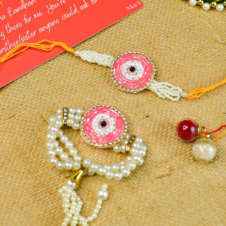 Beaded Pink Round Pearl And Stone Rakhi Hamper With Chocolates And Roli Chawal For Bhaiya And Bhabhi Customizable Options Includes Up To 7 Goodies - Top-down arrangement of two bracelets
