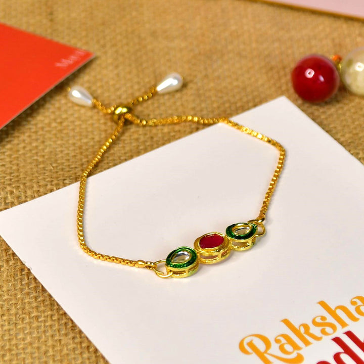Beaded Red And Green Bracelet Rakhi Hamper With Chocolates And Roli Chawal For Brother Customizable Options Includes Up To 7 Goodies - Close-up of gold and colored bracelet