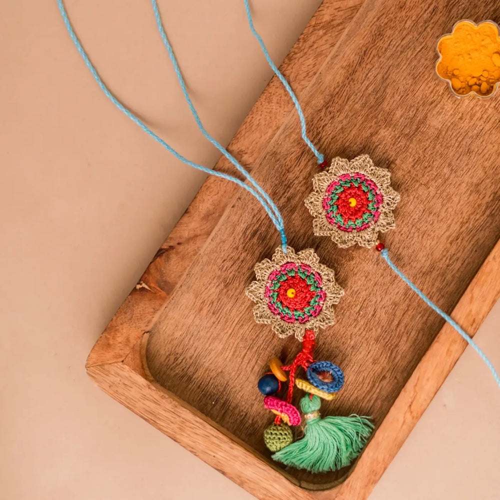 Handmade Crochet Golden Sunshine Bhaiya Bhabhi Rakhi With Roli Chawal Set Of 2 - Top View with Wooden Tray