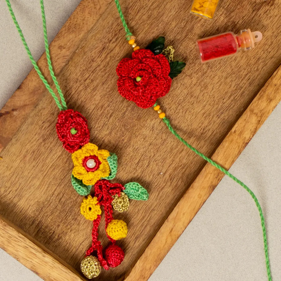 Handmade Crochet Surkh Gulab Bhaiya Bhabhi Rakhi With Roli Chawal Set Of 2 - Close-up on wooden tray