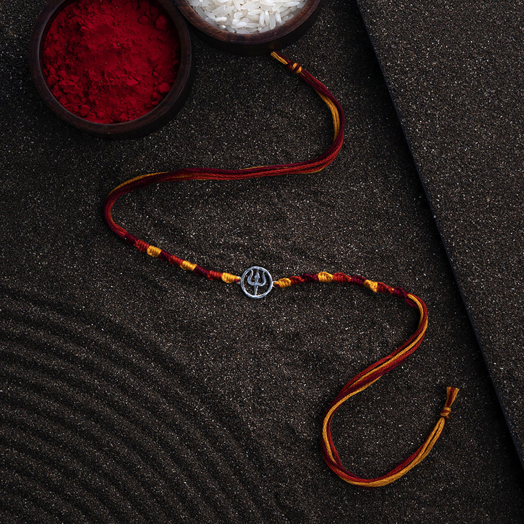 Handmade Trishul 925 Silver Rakhi With Roli Chawal For Brother - Laid Flat with Background Props