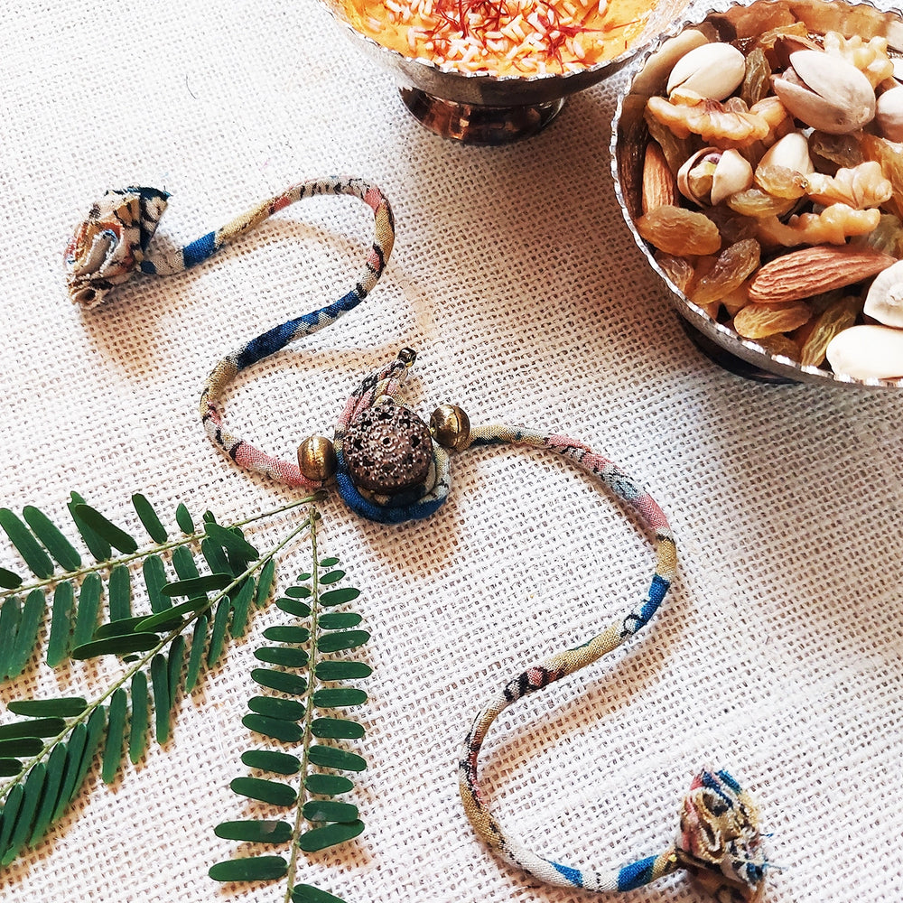 Handmade Dori Work Ambi Kalamkari Rakhi With Roli Chawal - Styled with Decorative Items