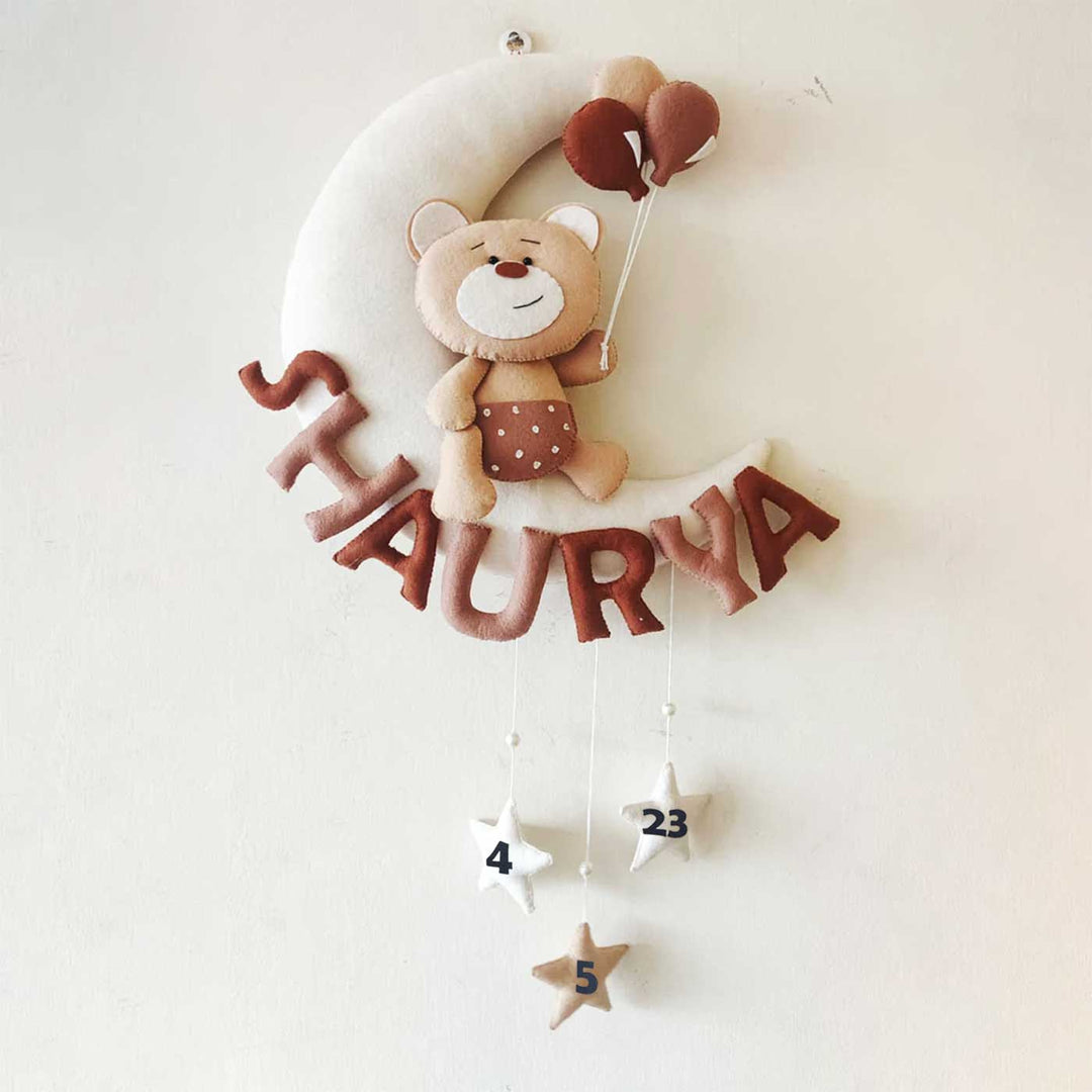 Hand Stitched Teddy Themed Felt Moon Nameplate With Birthdate For Kids Brown - Front View Hanging on Wall