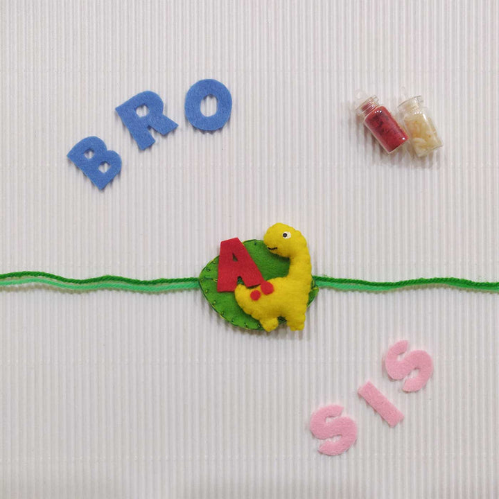 Personalized Handmade Dinosaur Theme Felt Kids Rakhi With Roli Chawal - Yellow dinosaur wristband with letters