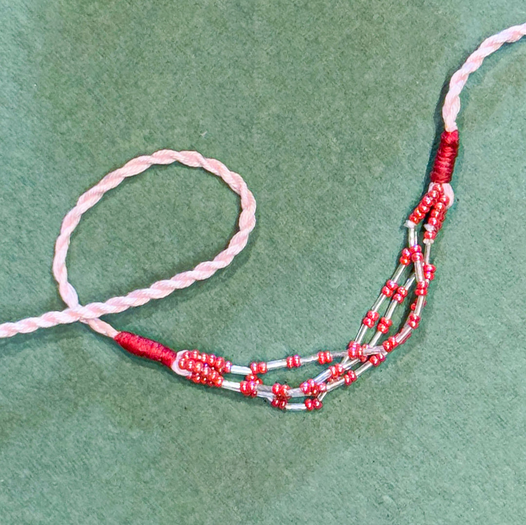 Handmade Reusable Pink Corel Cotton Rope Rakhi For Brother - Close-up of Beaded Section