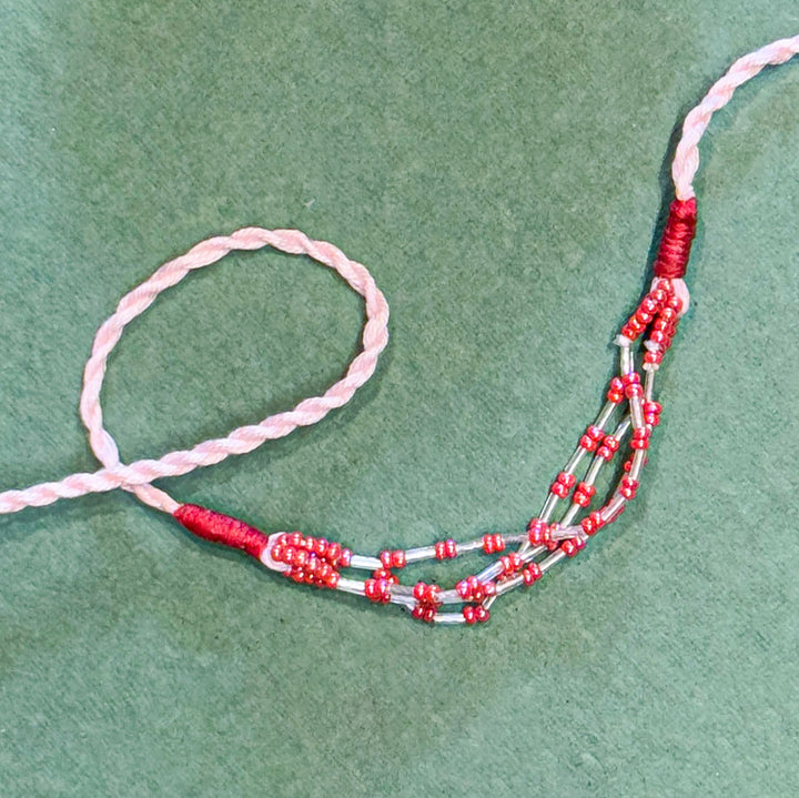 Handmade Reusable Pink Corel Cotton Rope Rakhi For Brother - Close-up of Beaded Section