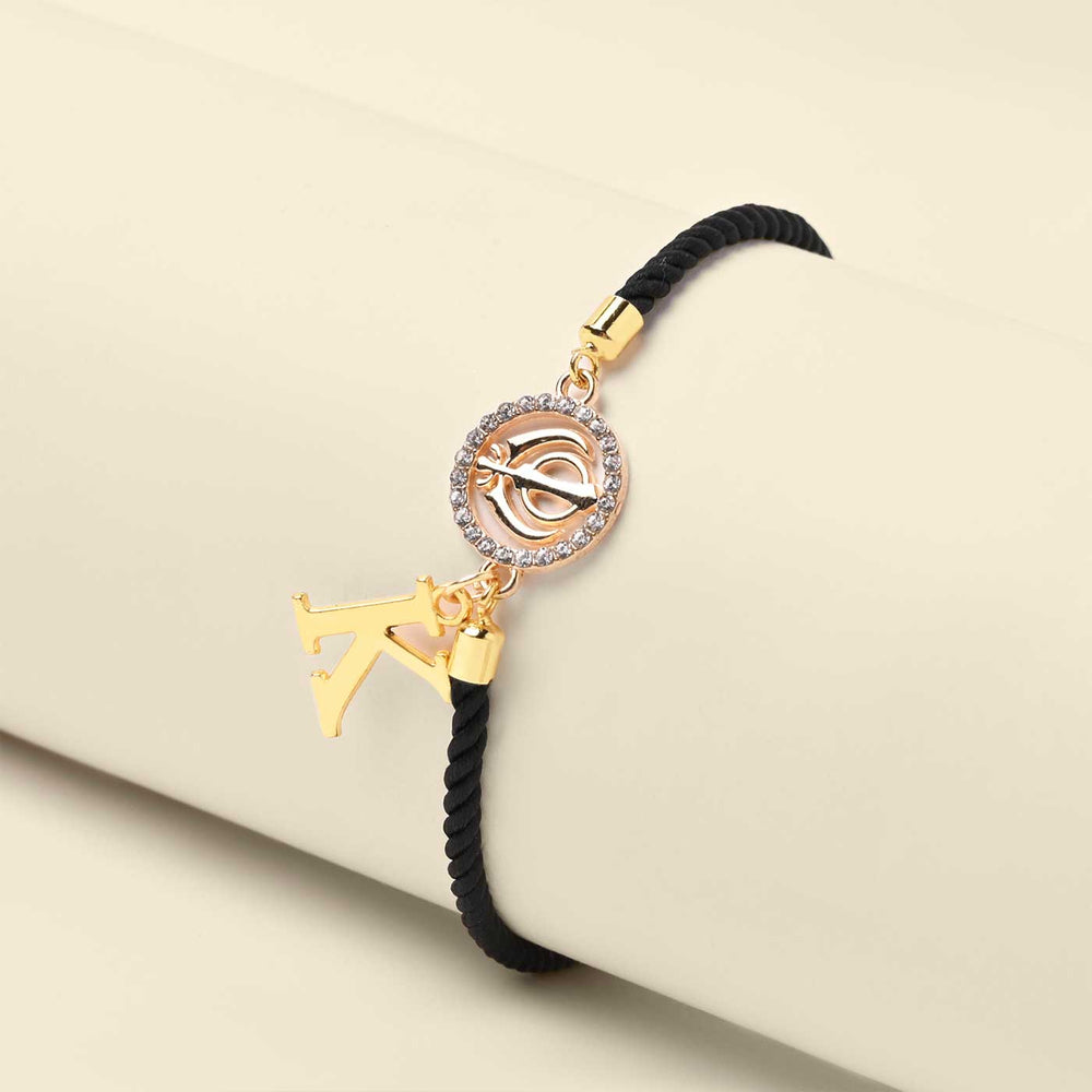 Personalized Handmade Sikh Design Monogram Metal Rakhi - Front View on Display Cylinder