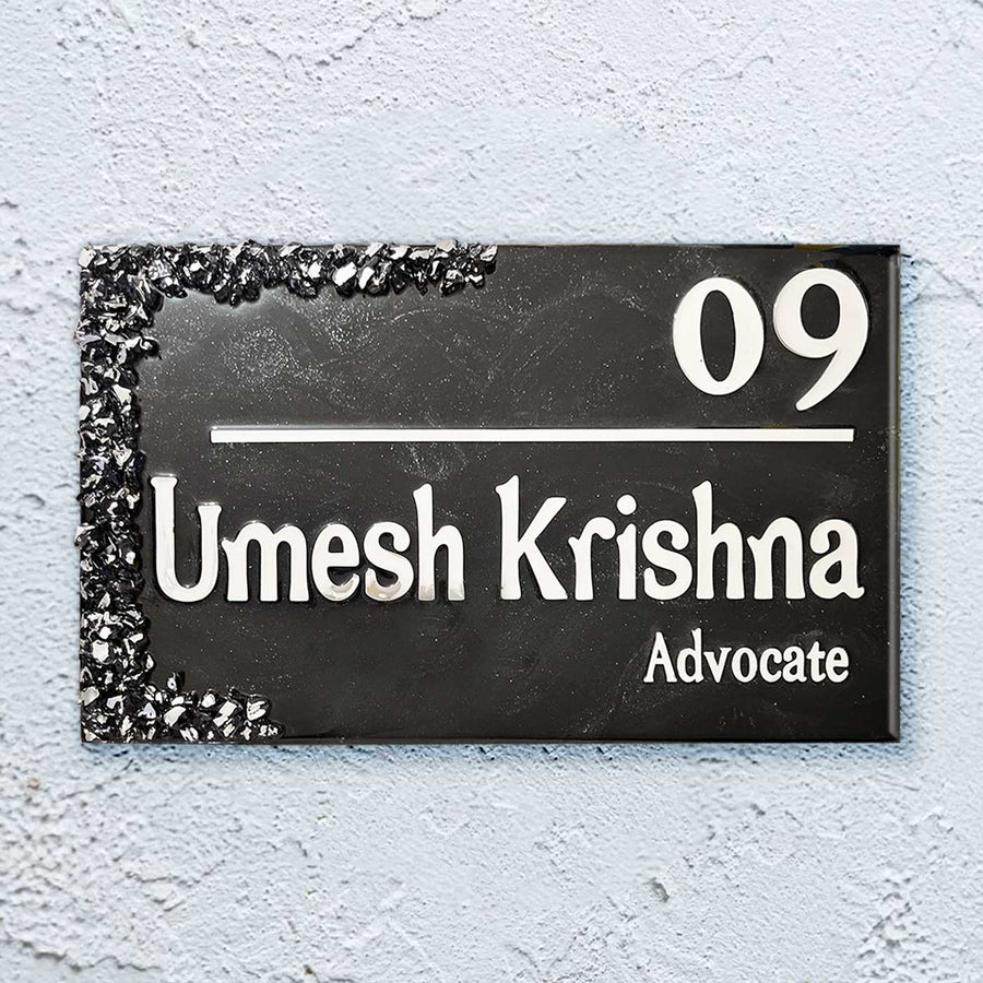 Personalized Black And Silver Resin Name Plate - Front View on Textured Wall