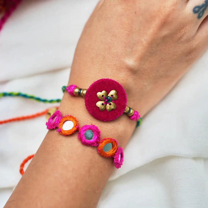 Handmade Mirror Work And Embroidery Only Love Rakhi With Roli Chawal Set Of 3 - Close-up Wrist View of Two Bracelets