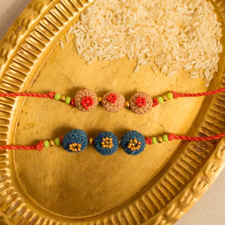 Handmade Crochet Round Ananta Rakhi With Roli Chawal Set Of 2 - Close-up of two bracelets