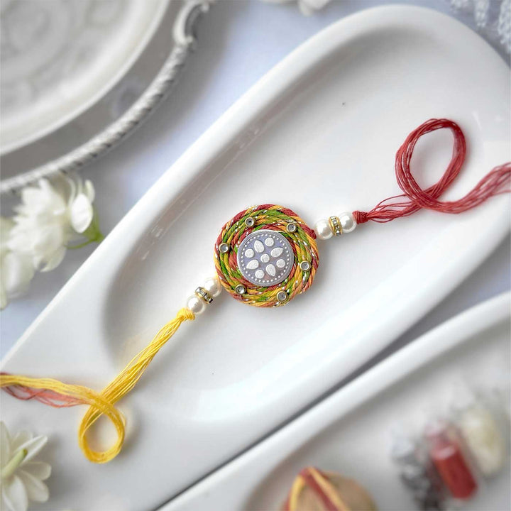 Handmade Lotus Design Silver Rakhi Hamper With Roli Chawal For Brother - Flat Lay with Rakhi on Plate