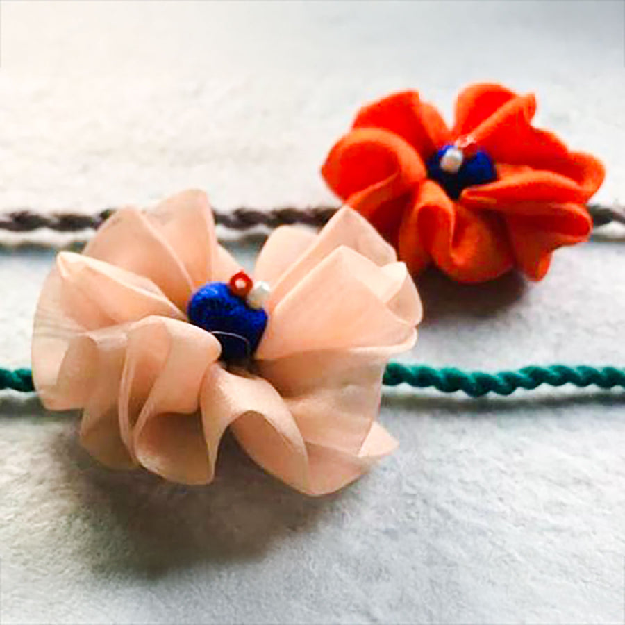 Handmade Flower Design Pom Pom Upcycled Fabric Rakhi With Roli Chawal For Brother - Close-up of Floral Detail