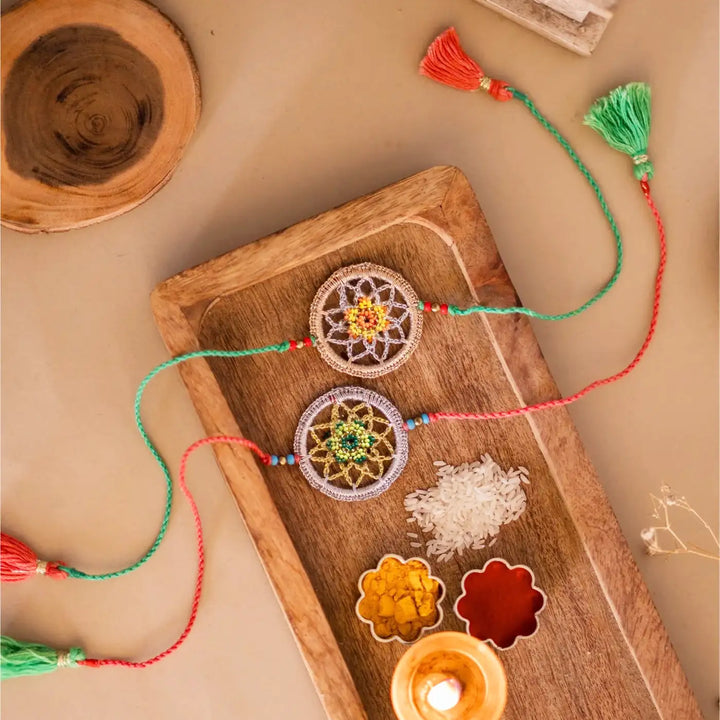 Handmade Crochet Dreamcatcher Rakhi With Roli Chawal Set Of 2 - Top view with ritual items