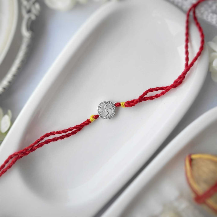 Handmade Swatik Design Silver Rakhi Hamper With Roli Chawal For Brother - Flat Lay of Full Rakhi Thread