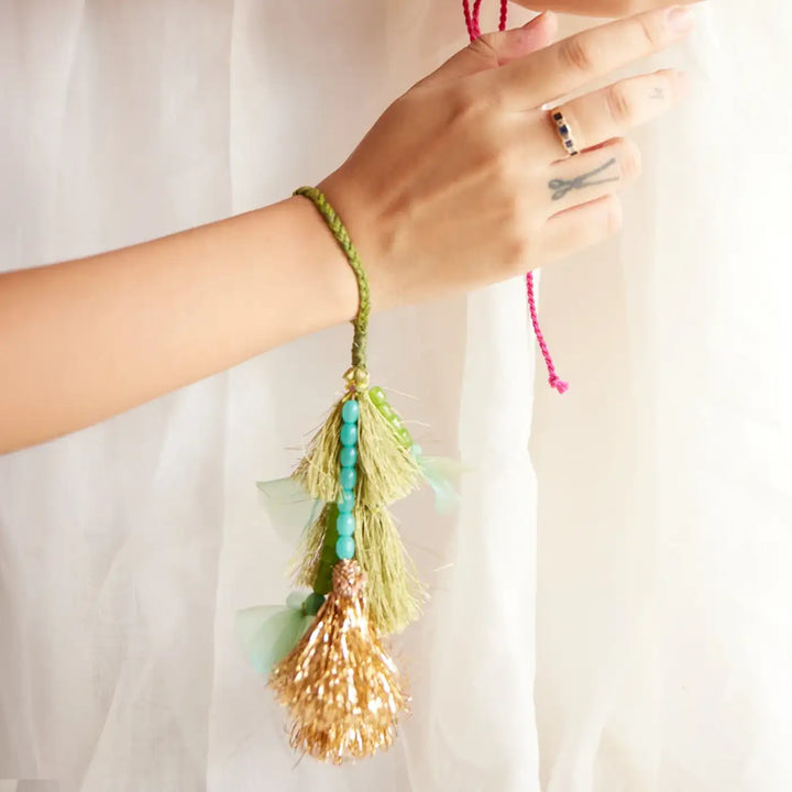 Handmade Embroidered Green And Golden Tassels Liza Bhaiya Bhabhi Rakhi With Roli Chawal Set Of 2 - Close-up of bracelet tassel