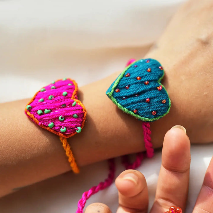 Handmade Embroidered Heart Shaped Only Love Rakhi With Roli Chawal Set Of 2 - Close-up of Heart Bracelets
