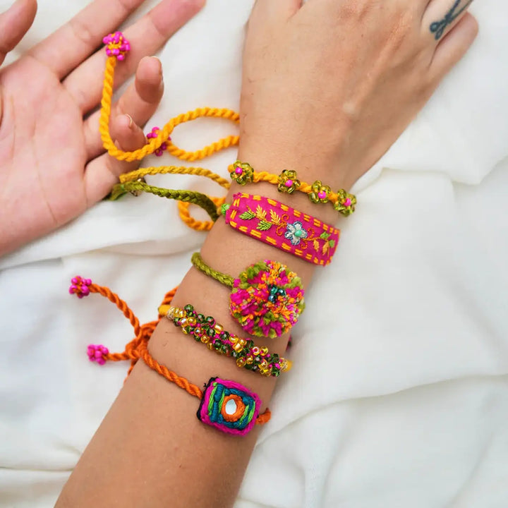 Handmade Embroidered And Beaded Chum Chum Rakhi With Roli Chawal Set Of 5 - Wrist Close-up with All Bracelets
