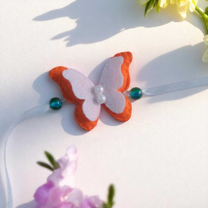 Customized Handmade Beaded Butterfly Theme Pom Pom Felt Rakhi With Roli Chawal For Kids - Decorative Butterfly with Beads Close-up
