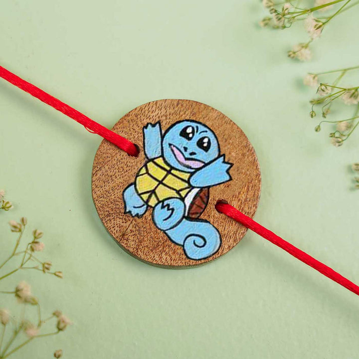 Personalized Hand Painted Squirtle Wooden Rakhi With Roli Chawal - Flat Lay Close-up View
