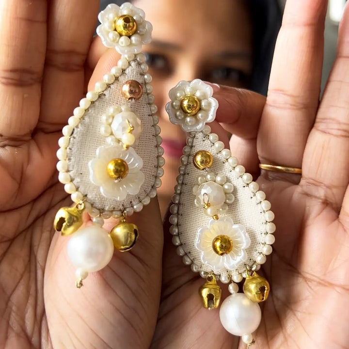 Hand Embroidered Beaded Ivory Bhaiya Bhabhi Rakhi With Roli Chawal Set Of 2 - Held Close-up Display in Hands