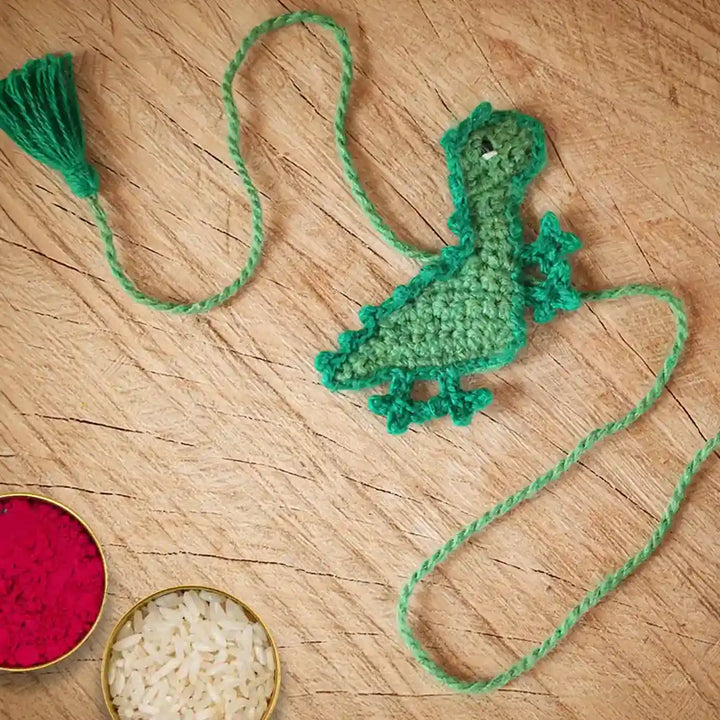 Handmade Crochet Dino Theme Kids Rakhi And Toy Combo With Roli Chawal Set Of 2 - Crochet Bookmark with Rice and Powder