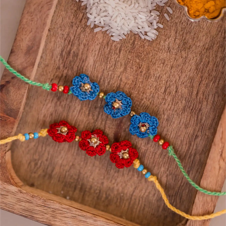Handmade Crochet Red And Blue Floral Rakhi With Roli Chawal Set Of 2 - Close-up of Floral Patterns