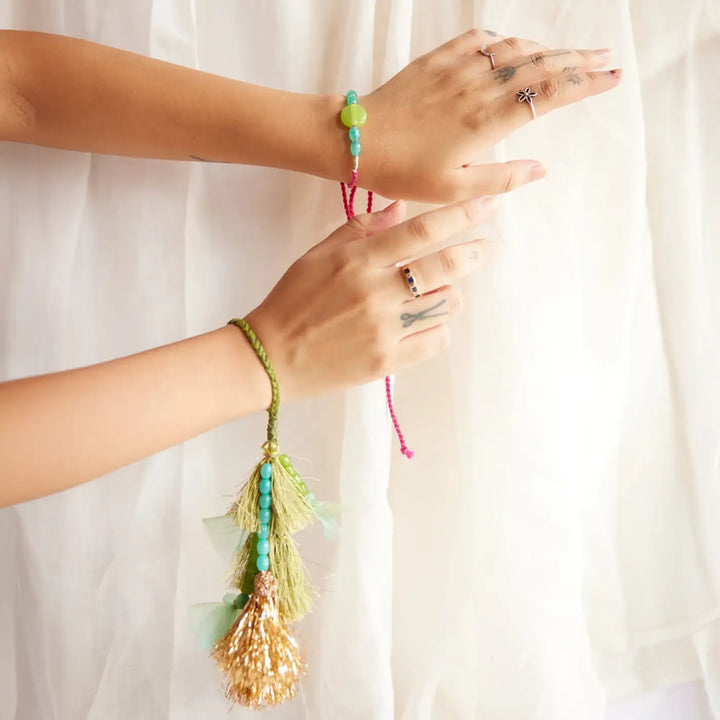 Handmade Embroidered Green And Golden Tassels Liza Bhaiya Bhabhi Rakhi With Roli Chawal Set Of 2 - Wristwear Display Showing Both Hands