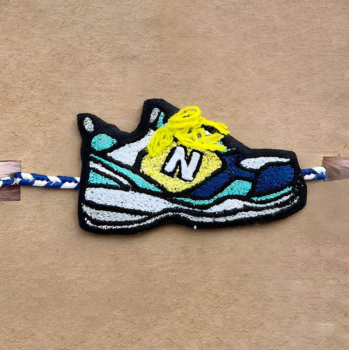 Handmade Reusable Shoe Pom Pom With N Letter Felt Rakhi For Brother - Close-up of Shoe Magnet