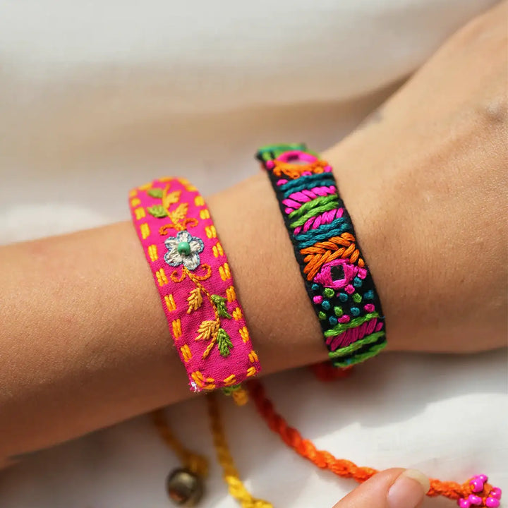 Handmade Embroidered Floral Rabari Rakhi With Roli Chawal Set Of 2 - Close-up of Bracelets on Wrist