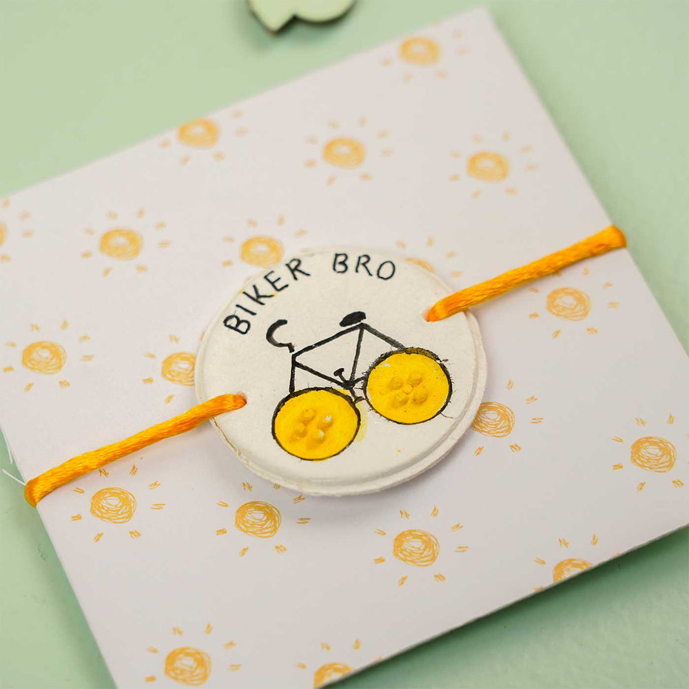 Personalized Hand Painted Biker Bro Clay Rakhi With Roli Chawal - Close-up on Packaging