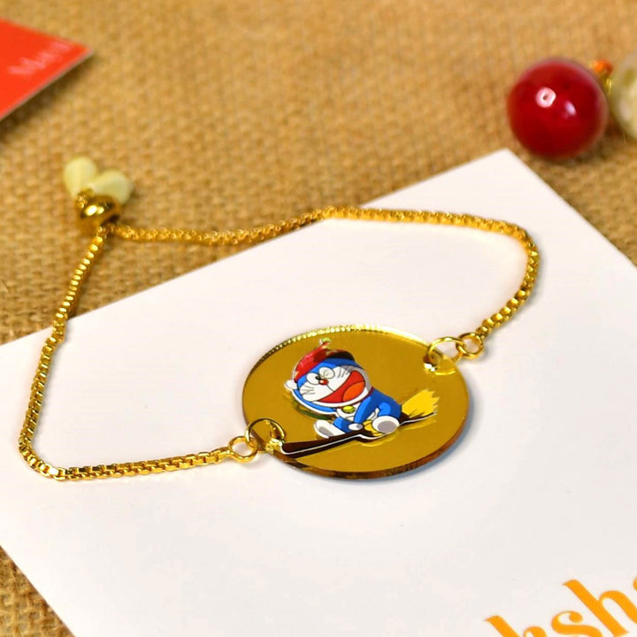 Doraemon Acrylic Bracelet Rakhi Hamper With Chocolates And Roli Chawal For Brother Customizable Options Includes Up To 7 Goodies - Close-up of Rakhi Bracelet
