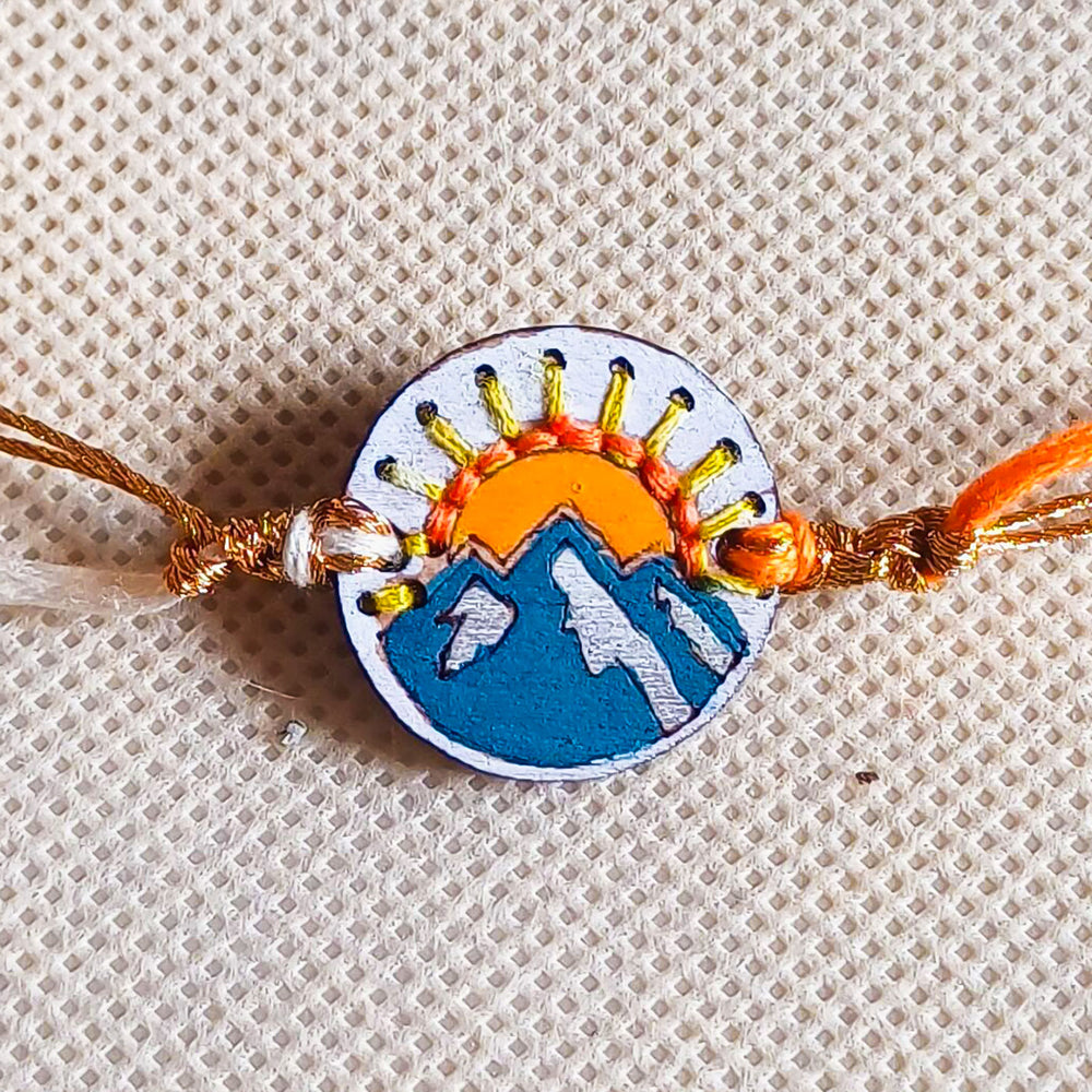 Handmade Mountain And Sun Wooden Rakhi With Roli Chawal For Brother - Close-up Front View Showing Details