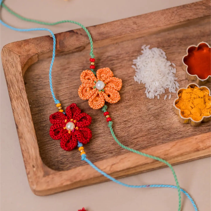 Handmade Crochet Red And Yellow Daffodil Rakhi With Roli Chawal Set Of 2 - Angle Showing Floral Thread Length