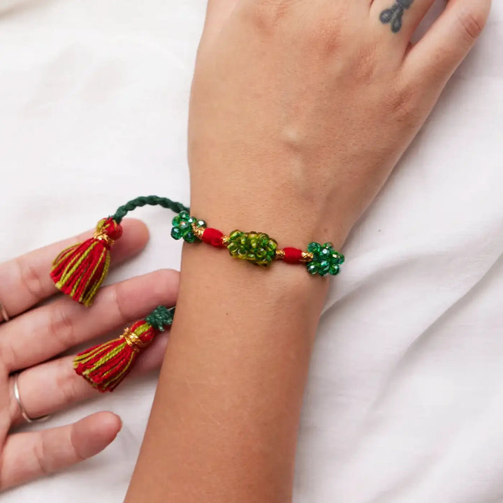 Handmade Beaded Green And Pink Zuzu Rakhi With Roli Chawal Set Of 2 - Close-up of Green Red Bracelet