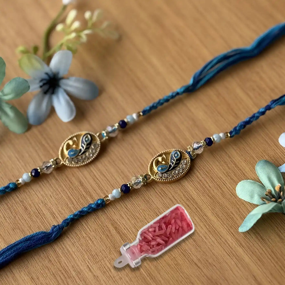 Handmade Beaded Peacock Rakhi With Roli Chawal - Pair Laid Flat with Props