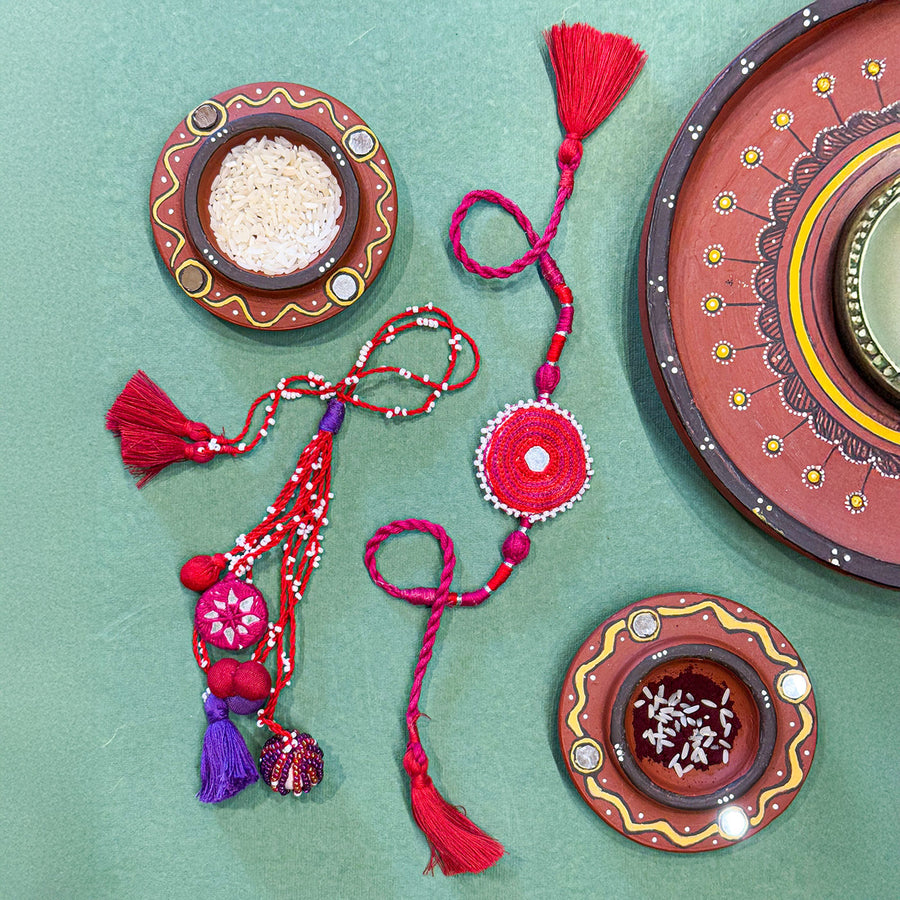 Handmade Reusable Pink Patwa Ari Mirror And Potli Rakhi For Bhaiya And Bhabhi - Styled Product Display